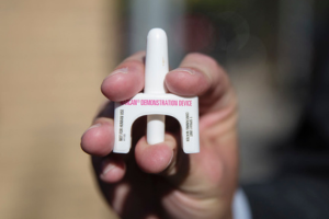 hand holding a narcan device