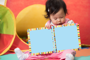 Toddler holding colorful book