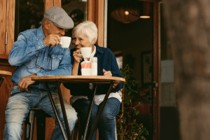 retired man and woman enjoying an outdoor cafe