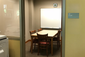 Small room with table and whiteboard