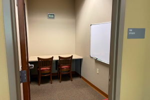 Small room with counter along wall and two chairs