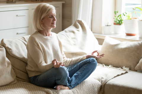 A calm woman on a light-colored sofa