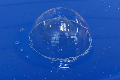 A bubble within a bubble on a blue tray