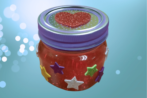 Mason jar with sparkling contents and stickers