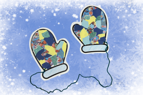 A pair of paper mittens connected with yarn and decorated with colorful scraps of paper.