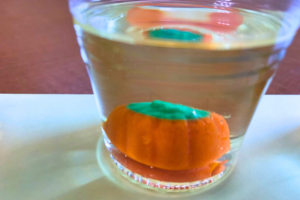 Pumpkin candy in glass of liquid