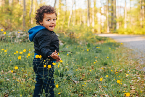 toddler standing near trail in fall