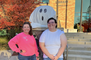 Librarians Andrea and Jess in costume outside the Delafield Library