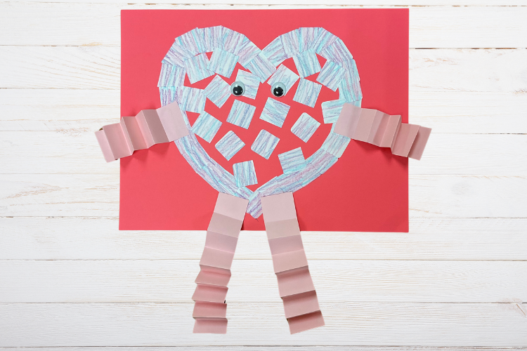 Construction paper heart with eyes and wavy legs