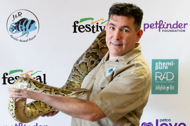 Man holding a large snake