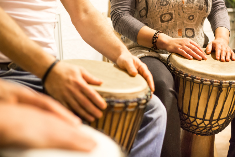 Three people playing drums