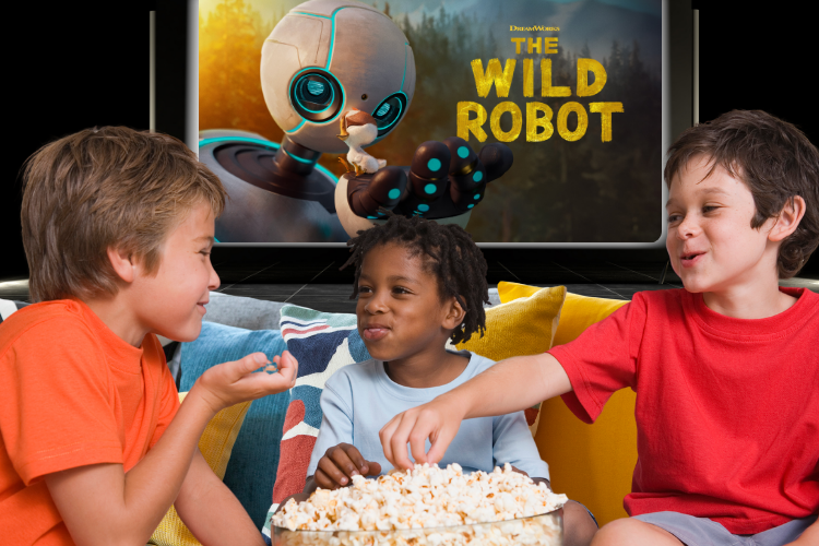 Three boys eating popcorn in front of a movie screen