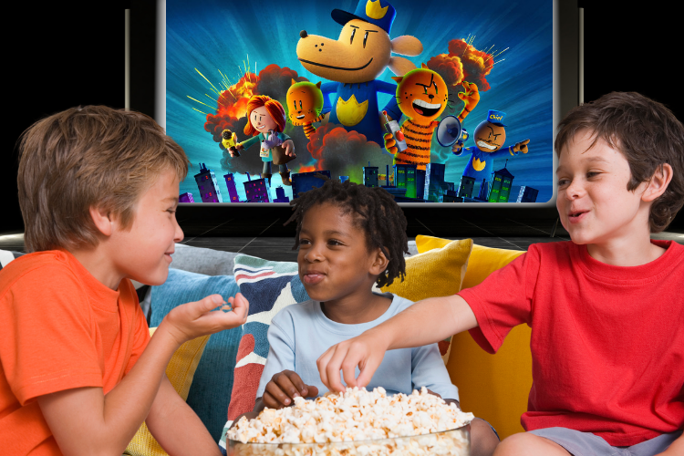 Three boys eating popcorn in front of a movie screen