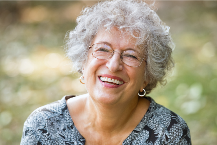 Smiling woman with short white hair