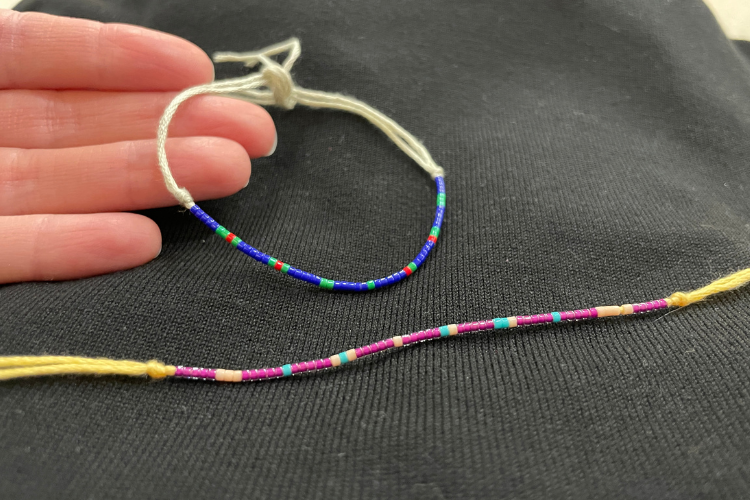 Two beaded bracelets with code patterned colors